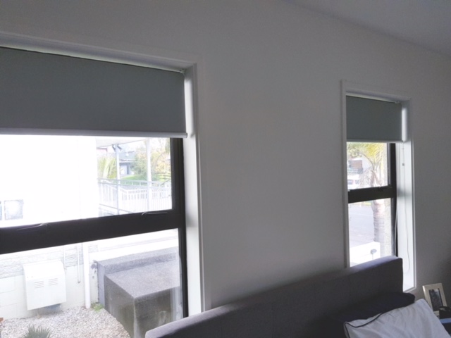 Blinds half closed in twin windows
