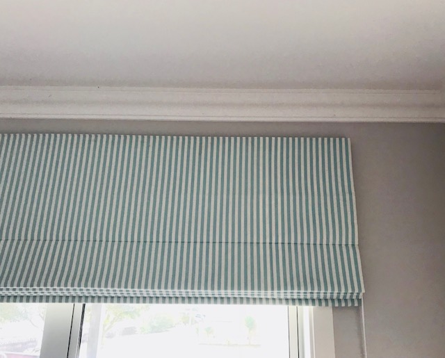 Green and white stripe fabric blind