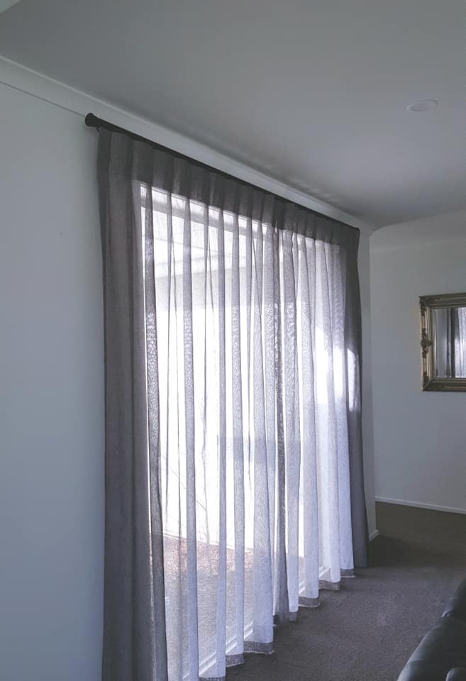 Charcoal sheer drapes contrasting white walls