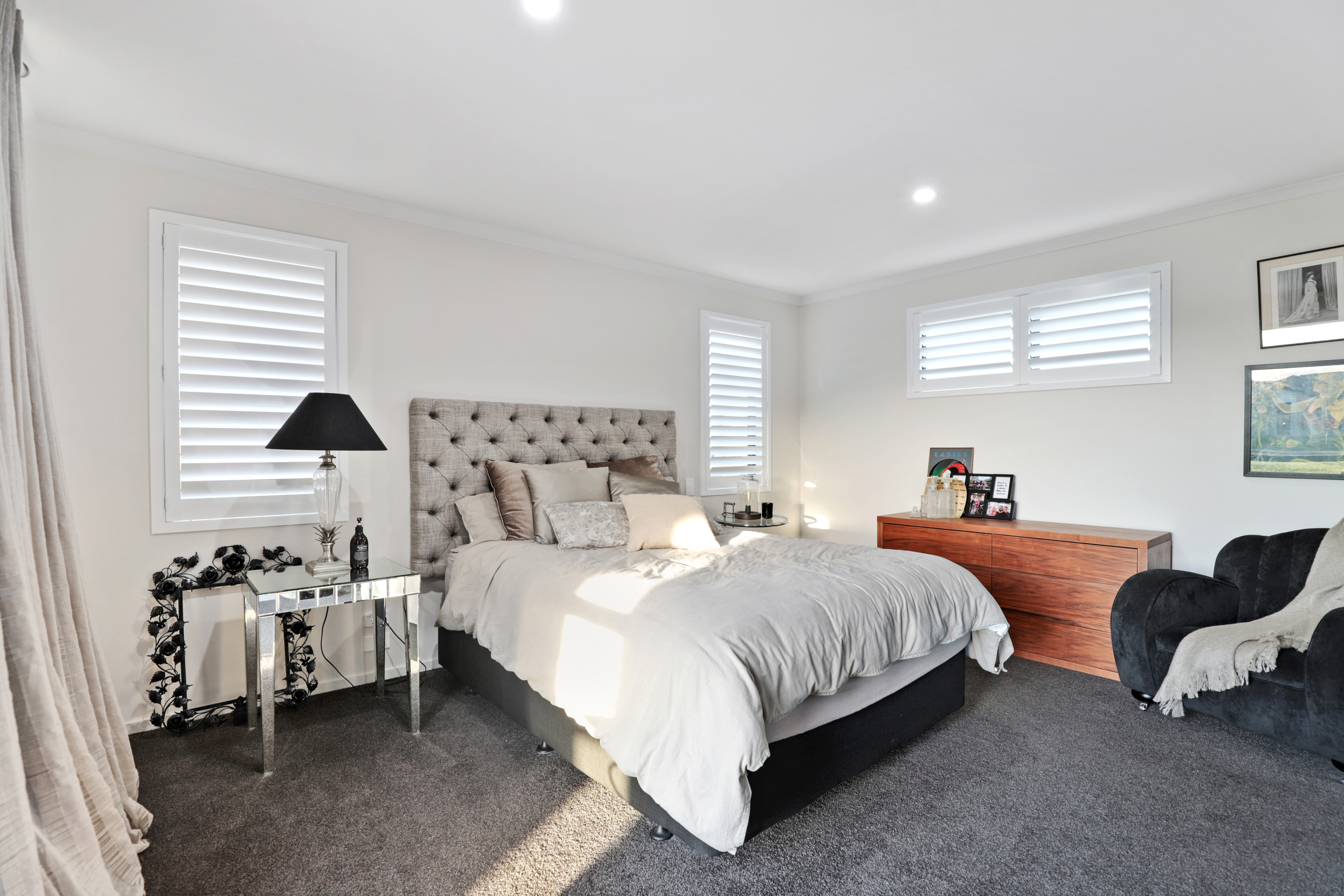 Main bedroom with cream drapes and venetian wooden blinds