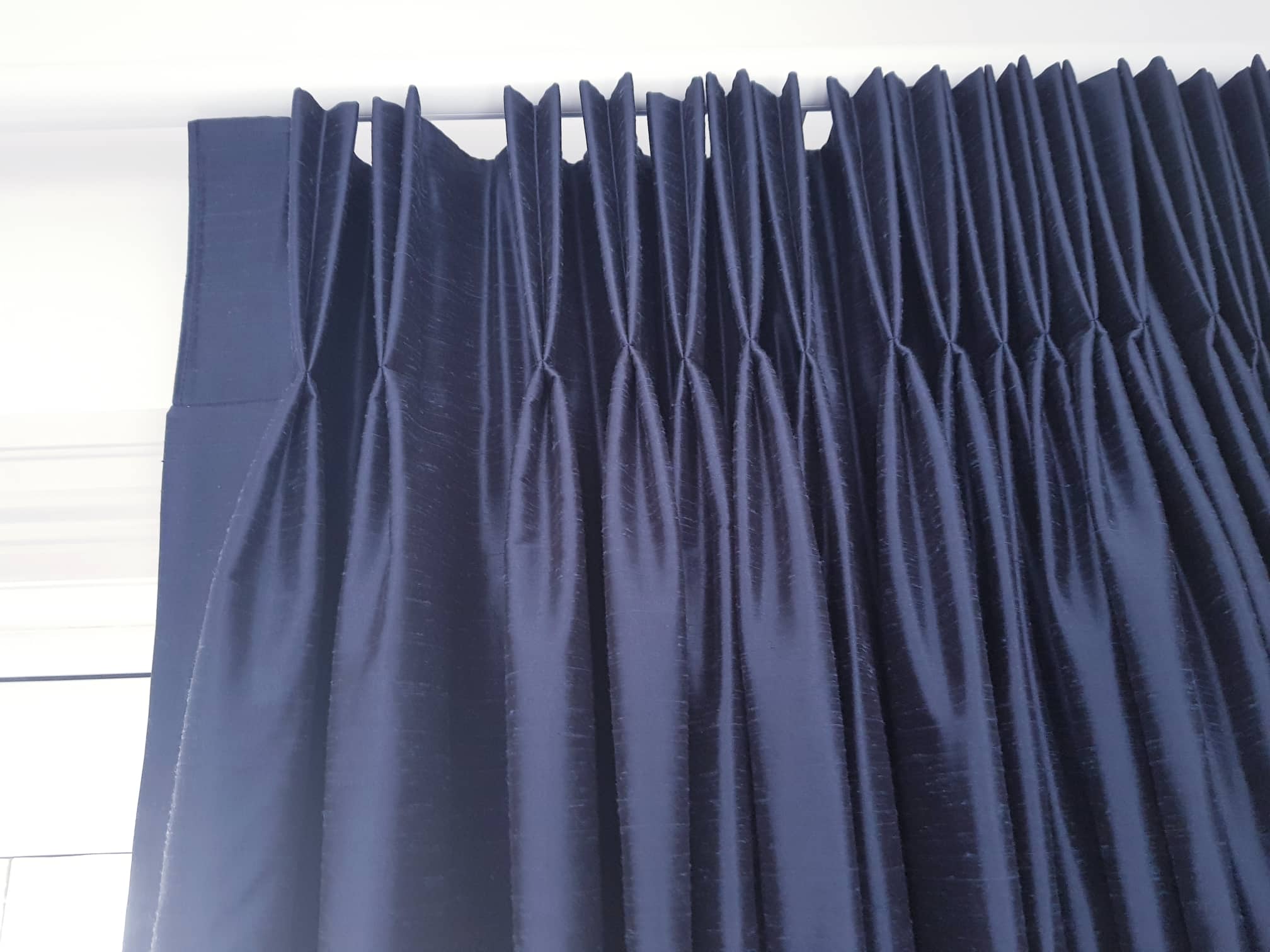 Close up of drape pleats in bed room